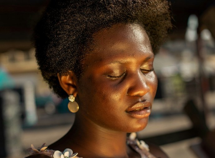 Person looking peaceful and reflective in warm light