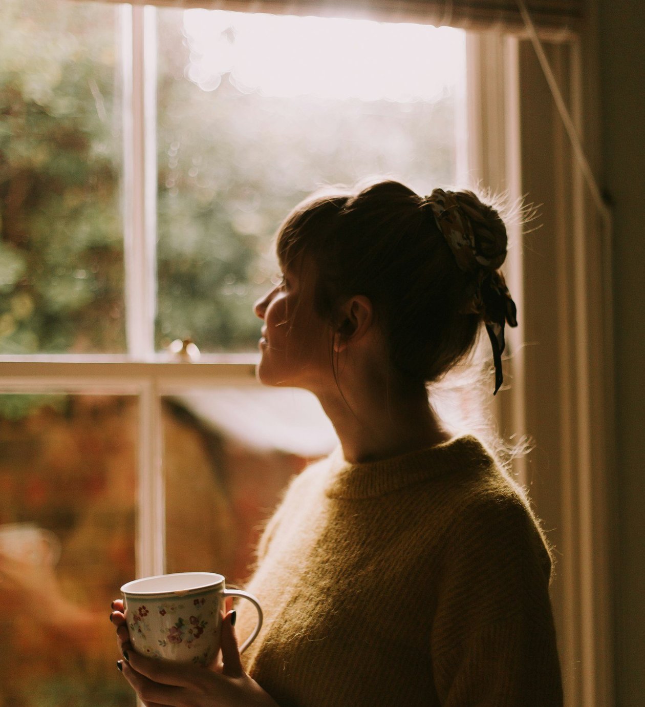 Person feeling calm and hopeful in soft natural light